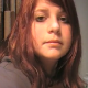 A girl sets up a camera in a bathroom and records herself peeing while staring at the camera. Peeing sounds are very crisp and clear in this high-quality video.